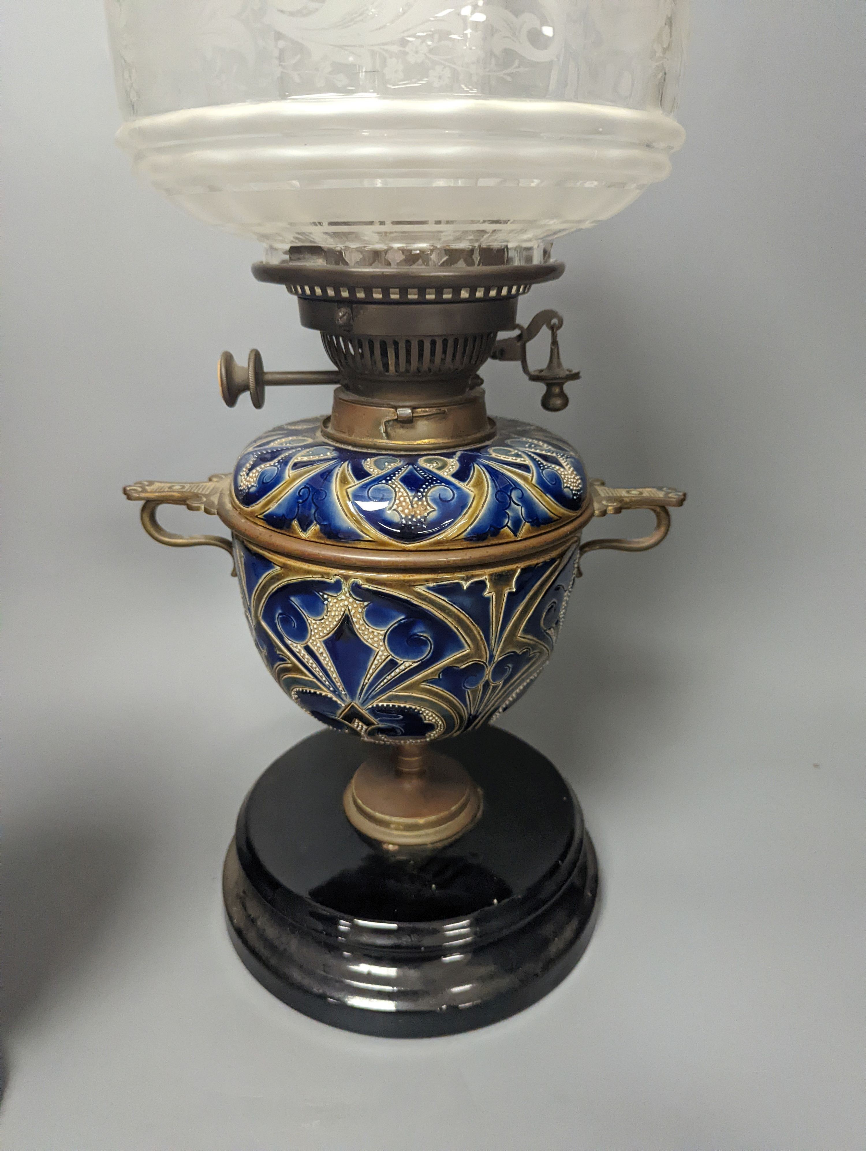 A Doulton Lambeth stoneware oil lamp and a German porcelain’owl’ lamp base, Oil lamp 54 cms high including funnel.